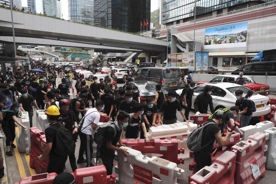 Protesters use barricades to surround the police headquarters in Hong Kong on Friday, June 21, 2019. Several hundred mainly student protesters gathered outside Hong Kong government offices Friday morning, with some blocking traffic on a major thoroughfare, after a deadline passed for meeting their demands related to controversial extradition legislation that many see as eroding the territory's judicial independence. (AP Photo/Kin Cheung)