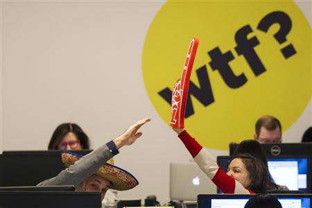 Buzzfeed employees trade high-fives while working at the company's headquarters in New York January 9, 2014. BuzzFeed has come a long way from cat lists. REUTERS/Brendan McDermid