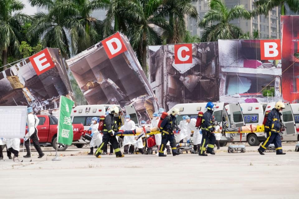 Firefighters and medical personnel carry dummy victims on stretchers during a drill in New Taipei (Copyright 2022 The Associated Press. All rights reserved.)