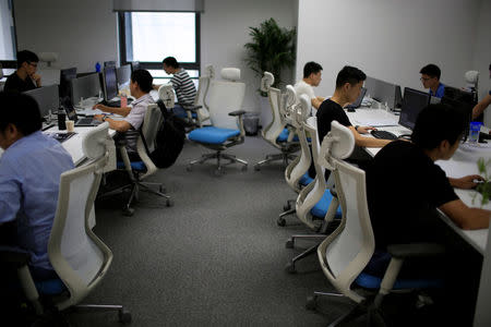 Employees of WM Motor Technology Co., Ltd. work at their office in shanghai, China, August 1, 2016. REUTERS/Aly Song