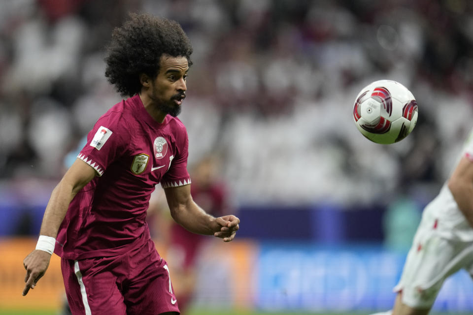 Qatar's Akram Afif goes for the ball during the Asian Cup Group A soccer match between Tajikistan and Qatar at Al Bayt stadium, in Al Khor, Qatar, Wednesday, Jan. 17, 2024. (AP Photo/Aijaz Rahi)