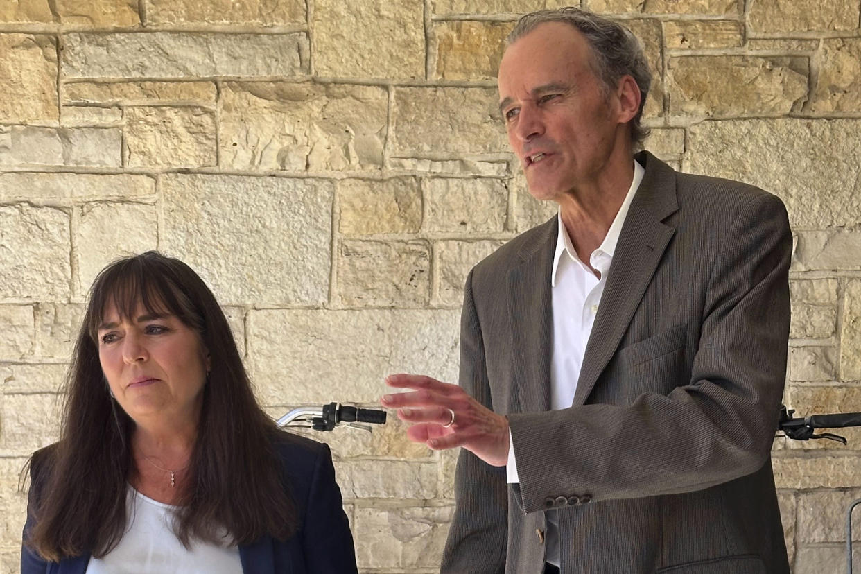 Former University of Wisconsin-La Crosse Chancellor Joe Gow and his wife, Carmen Wilson, take questions after a hearing before a committee that will determine whether he can teach after being fired as the campus leader for making pornographic videos on Friday, Sept. 20, 2024, in Madison, Wis. (AP Photo/Scott Bauer)