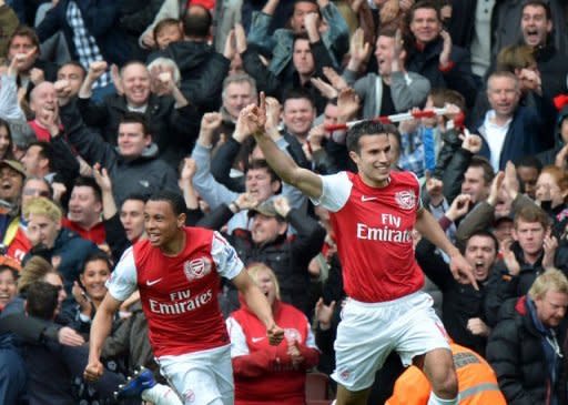 Arsenal's Dutch striker Robin van Persie (right) celebrates after scoring during the Premier League match against Norwich City at The Emirates Stadium in north London. Arsenal's bid for a top-four finish suffered a major setback as Steve Morison's late goal earned Norwich a deserved point in a six-goal thriller at the Emirates. The match ended 3-3