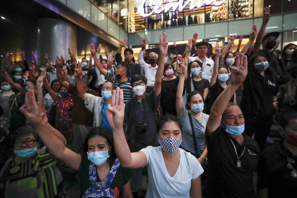 Pro-democracy demonstrators flash a three-finger salute of defiance during a protest rally at the Silom business district in Bangkok, Thailand, Thursday, Oct. 29, 2020. The protesters continue to gather Thursday with their three main demands of Prime Minister Prayuth Chan-ocha's resignation, changes to a constitution that was drafted under military rule and reforms to the constitutional monarchy. (AP Photo/Sakchai Lalit)