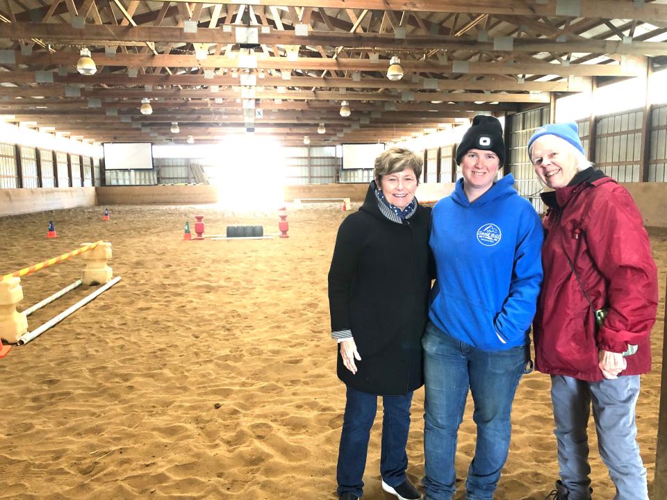 From left, Janet Dix with Betsy and Virginia Shaw inside arena at Sand Hill Stables horse farm.