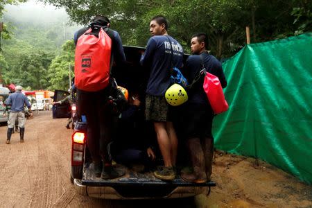 Divers arrive the Tham Luang cave complex, where 12 schoolboys and their soccer coach are trapped inside a flooded cave, in the northern province of Chiang Rai, Thailand, July 8, 2018. REUTERS/Tyrone Siu