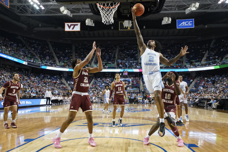 North Carolina guard Caleb Love (2) drives against Boston College forward Devin McGlockton (21) during the first half of an NCAA college basketball game at the Atlantic Coast Conference Tournament in Greensboro, N.C., Wednesday, March 8, 2023. (AP Photo/Chuck Burton)