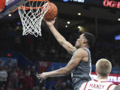 Mississippi State guard Robert Woodard (12) goes up for a shot over Oklahoma forward Brady Manek (35) during the second half of an NCAA college basketball game in Oklahoma City, Saturday, Jan. 25, 2020. (AP Photo/Kyle Phillips)