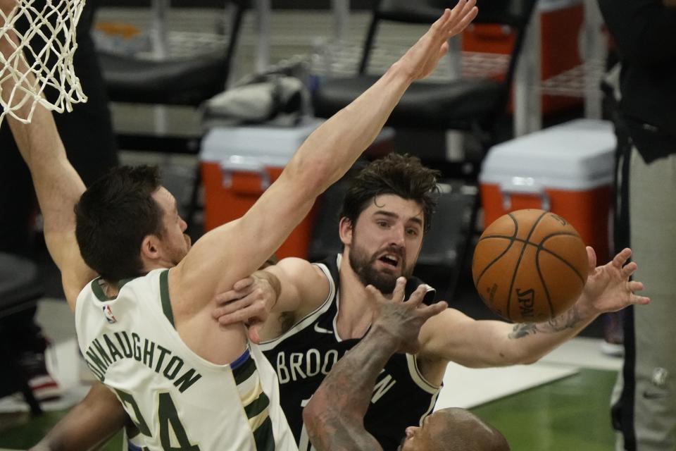 Milwaukee Bucks' Pat Connaughton knocks the ball from Brooklyn Nets' Joe Harris during the first half of Game 4 of the NBA Eastern Conference basketball semifinals game Sunday, June 13, 2021, in Milwaukee. (AP Photo/Morry Gash)