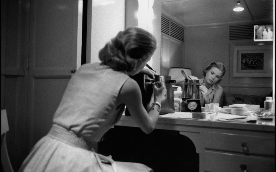Grace Kelly in her Hollywood dressing room with the famous French made Hermes handbag  - Credit: Dennis Stock 