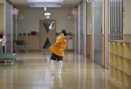 A boy plays with a paper plane at the corridor of the Emporium kindergarten in Koriyama, west of the tsunami-crippled Fukushima Daiichi nuclear power plant, Fukushima prefecture February 28, 2014. REUTERS/Toru Hanai