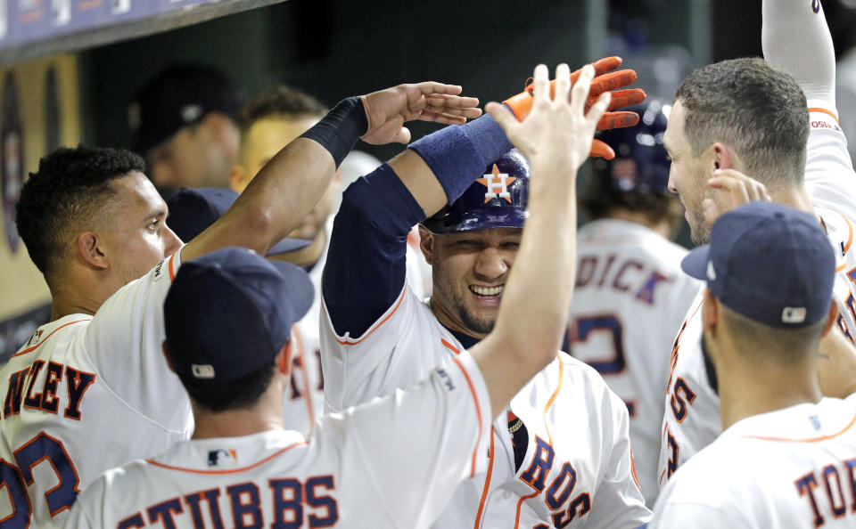 Houston Astros' Yuli Gurriel is congratulated in the dugout after hitting a home run against the Texas Rangers during the fifth inning of a baseball game Tuesday, Sept. 17, 2019, in Houston. (AP Photo/David J. Phillip)