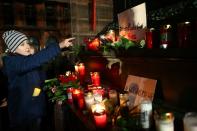 People attend a vigil for the victims of a shooting in Hanau