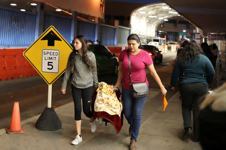 Women cross the U.S. border with Mexico carrying a baby in Nogales, Arizona, U.S., January 30, 2017. REUTERS/Lucy Nicholson