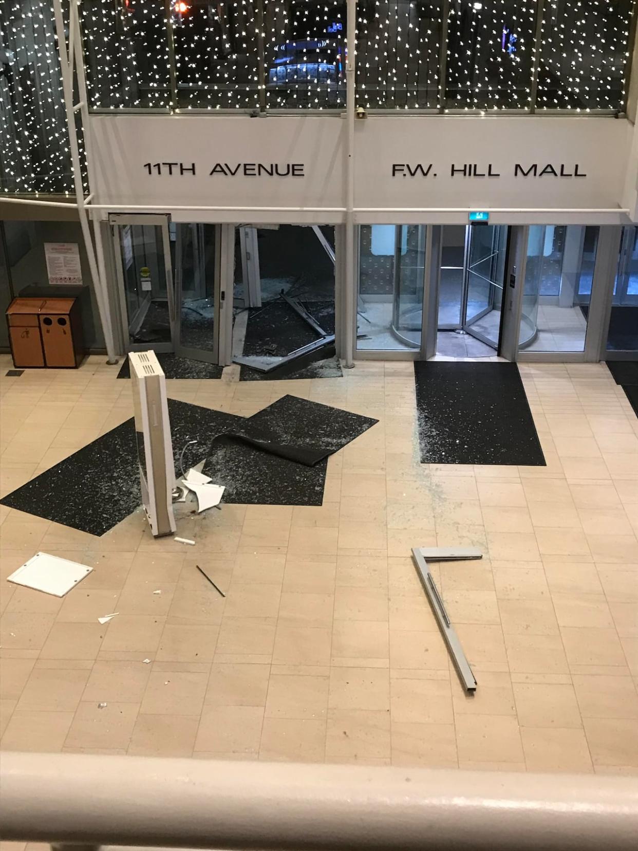 This photo, sent to CBC by a woman who says her son works a night shift at the Cornwall Centre, shows damage to the mall's 11th Street entrance. Regina police the driver of a stolen cab crashed into multiple businesses, including the downtown mall, early Saturday morning. (Submitted by Elizabeth Simmons - image credit)