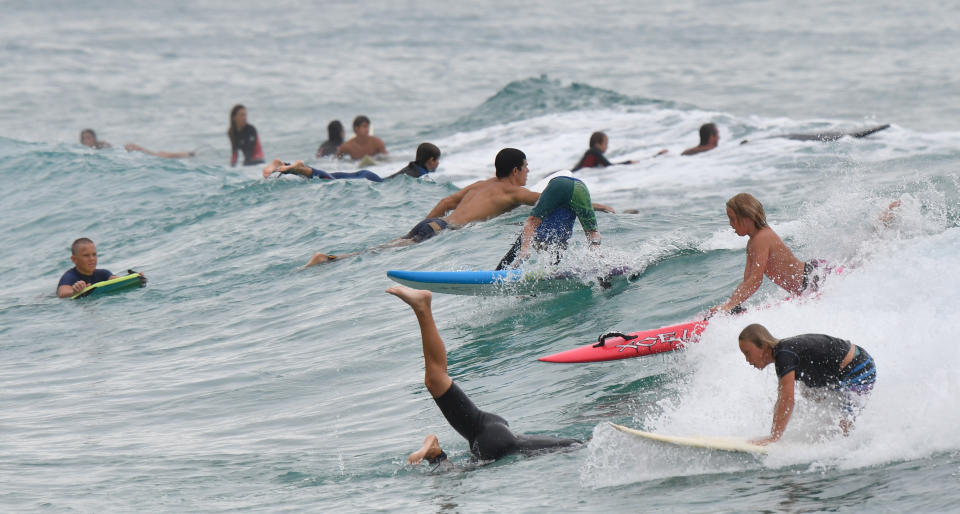 Surfers are seen at Burleigh Heads on the Gold Coast as Queensland practices social-distancing rules amid the coronavirus pandemic.