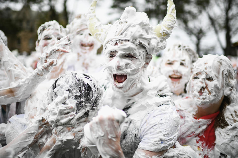 <p>Students from St Andrews University indulge in a tradition of covering themselves with foam to honor the “academic family” on Lower College Lawn on Oct. 23, 2017, in St Andrews, Scotland. (Photo: Jeff J Mitchell/Getty Images) </p>