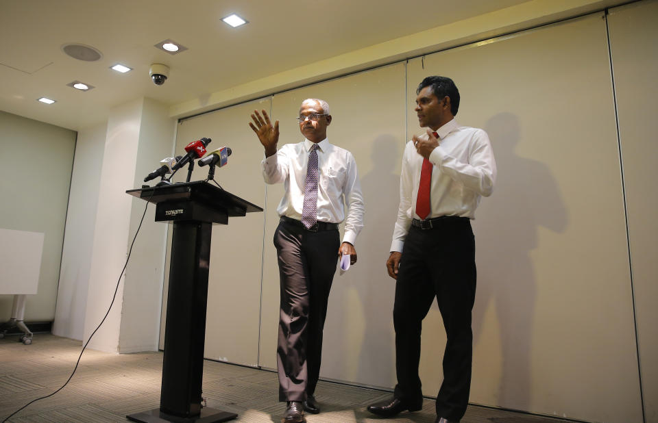 Maldives' opposition presidential candidate Ibrahim Mohamed Solih, left, and his running mate, Faisal Naseem, leave after addressing media in Male, Maldives, Monday, Sept. 24, 2018. A longtime but little-known lawmaker Solih declared victory at his party's campaign headquarters in Male in a contentious election widely seen as a referendum on the island nation's young democracy. (AP Photo/Eranga Jayawardena)