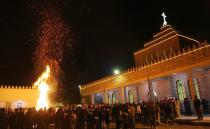 <p>Christmas has only been an official holiday in Iraq since 2008. Christians gather at their local church and pray next to a large bonfire. The service ends with the Bishop blessing the congregation and touching one of the congregants. The congregant touches someone next to them and the process continues until every attendee has gotten the "Touch of Peace."</p>