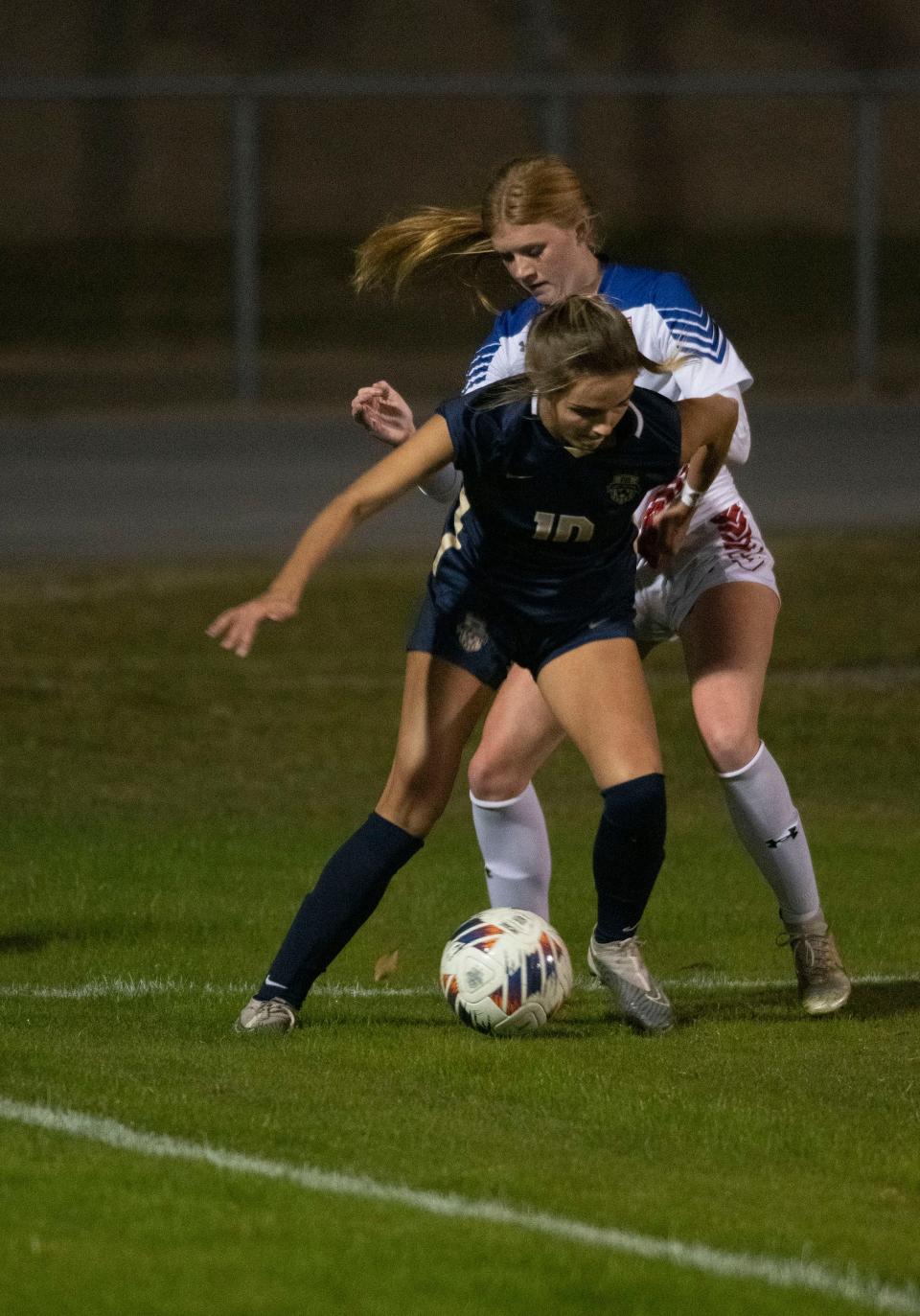 Gulf Breeze forward Skylar Hendricks (No. 10) battles Pace defender Lacie Goodale (No. 3) for possession in the corner during a District 1-6A match Wednesday night.