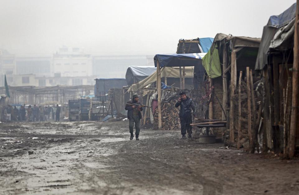 Afghan police forces patrol near the site of a deadly suicide attack, in Kabul, Afghanistan, Thursday, Feb. 20, 2014. A suicide bomber on foot struck a compound belonging to the minority Ismaili community, who make up a branch of Shiite Islam. The compound houses a cultural center, library and a hospital. The ministry of interior called the security guard — who died trying to tackle the bomber — a hero. (AP Photo/Massoud Hossaini)