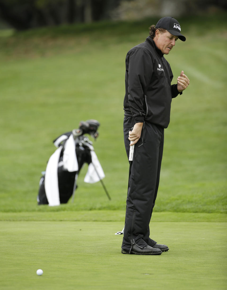 Phil Mickelson reacts after missing a birdie putt on the first green during the final round of the AT&T Pebble Beach Pro-Am golf tournament, Sunday, Feb. 9, 2014, in Pebble Beach, Calif. (AP Photo/Eric Risberg)