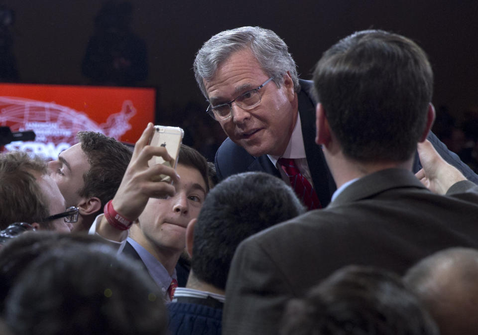 Former Florida Gov. Jeb Bush pauses for a photo as he greets people in the audience after speaking during the Conservative Political Action Conference (CPAC) in National Harbor, Md., Friday, Feb. 27, 2015. (AP Photo/Carolyn Kaster)