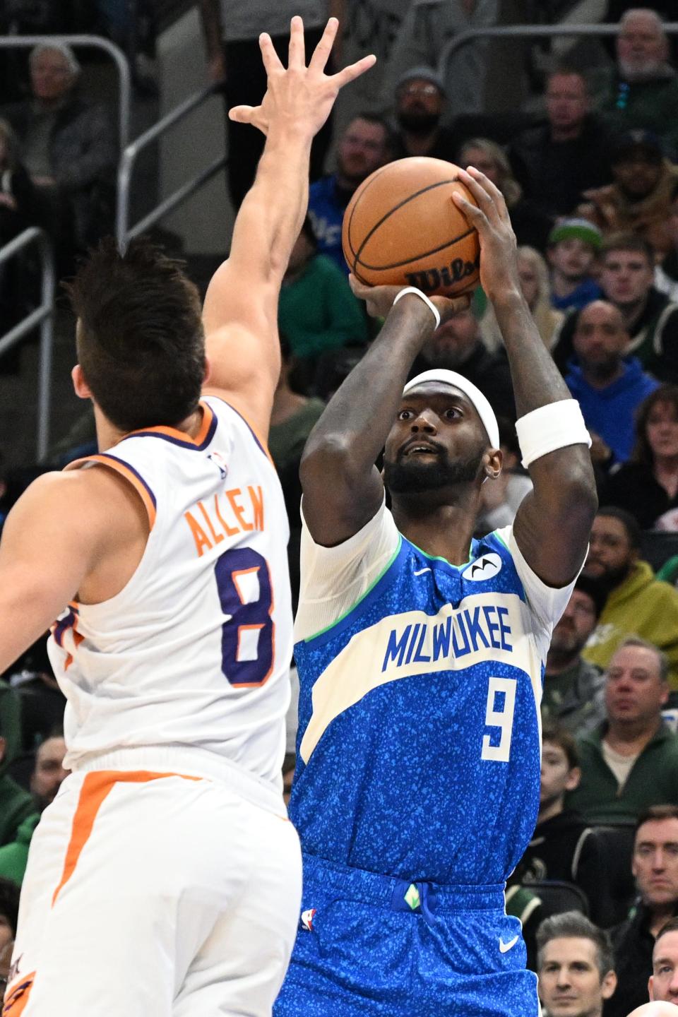 Milwaukee Bucks forward Bobby Portis (9) shoots the ball against Phoenix Suns guard Grayson Allen (8) in the first half at Fiserv Forum on March 17, 2024.