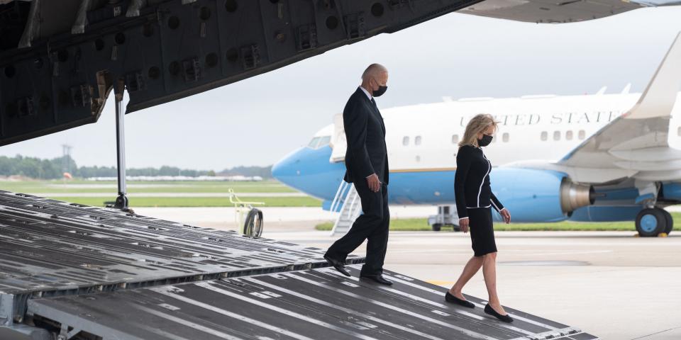 US President Joe Biden and First Lady Jill Biden walk off a military airplane.