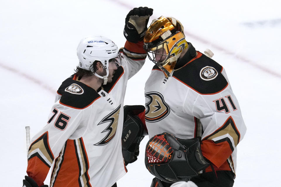 Anaheim Ducks goaltender Anthony Stolarz (41) is congratulated by Josh Mahura (76) after the team's 5-2 victory over the San Jose Sharks in an NHL hockey game Tuesday, April 26, 2022, in San Jose, Calif. (AP Photo/Tony Avelar)