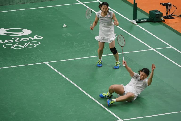 Japan's Misaki Matsutomo (L) and Ayaka Takahashi react after beating Denmark's Christinna Pedersen and Kamilla Rytter Juhl during the women's doubles gold medal badminton match on August 18, 2016