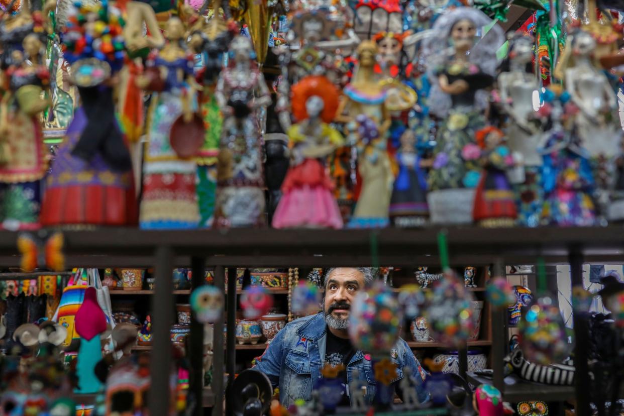 Elton Monroy Duran, 45, of Detroit, walks through Xochj’s Mexican Imports looking at Diá de Los Muertos figurines on Tuesday, March 5, 2024. Duran says the goal of his conceptual art his to create a visibly Mexican identity that inspires respect and amplifies the Latin voices within the community. “” And the thing is, instead of recognizing the identity of this place (southwest Detroit), you know, they're starting to push the agenda of that it’s a diverse community,” says Duran, “What are you talking about, a diverse community? The world is diverse, but this community, you know, is full of Mexicans.”