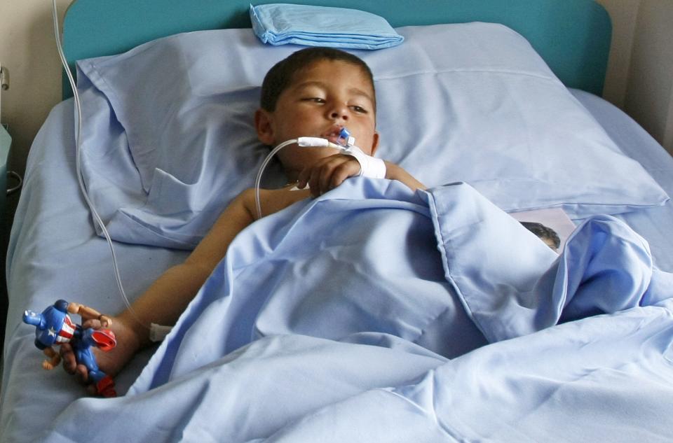 A boy receives treatment at a military hospital in Kabul, after being wounded during a suicide attack at a volleyball match on Sunday in the Yahya Khail district of Paktika province, November 24, 2014. A suicide bomber detonated his explosive vest in a crowd of spectators at a volleyball match in Afghanistan on Sunday, killing 45 people, a provincial official said, as foreign troops withdraw from the country after more than a decade of fighting. REUTERS/Mohammad Ishaq (AFGHANISTAN - Tags: CIVIL UNREST TPX IMAGES OF THE DAY)