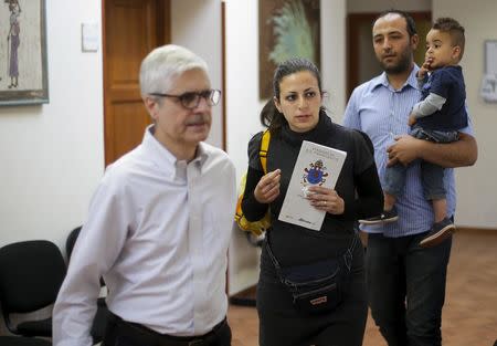 Syrian couple Hassan Zaheda, 31, and Nour Essa (C), 30, walk with their son Riad, 2, and a member of the Sant'Egidio community following an interview with Reuters in Rome, Italy, April 20, 2016. REUTERS/Max Rossi