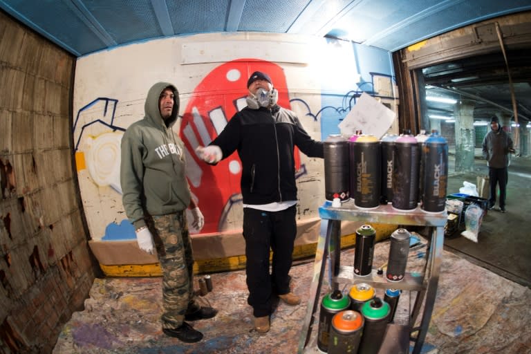 Bronx-based graffiti artist, turned professional muralist, BG183, works with one of his crew on a project in an old Bronx warehouse in New York