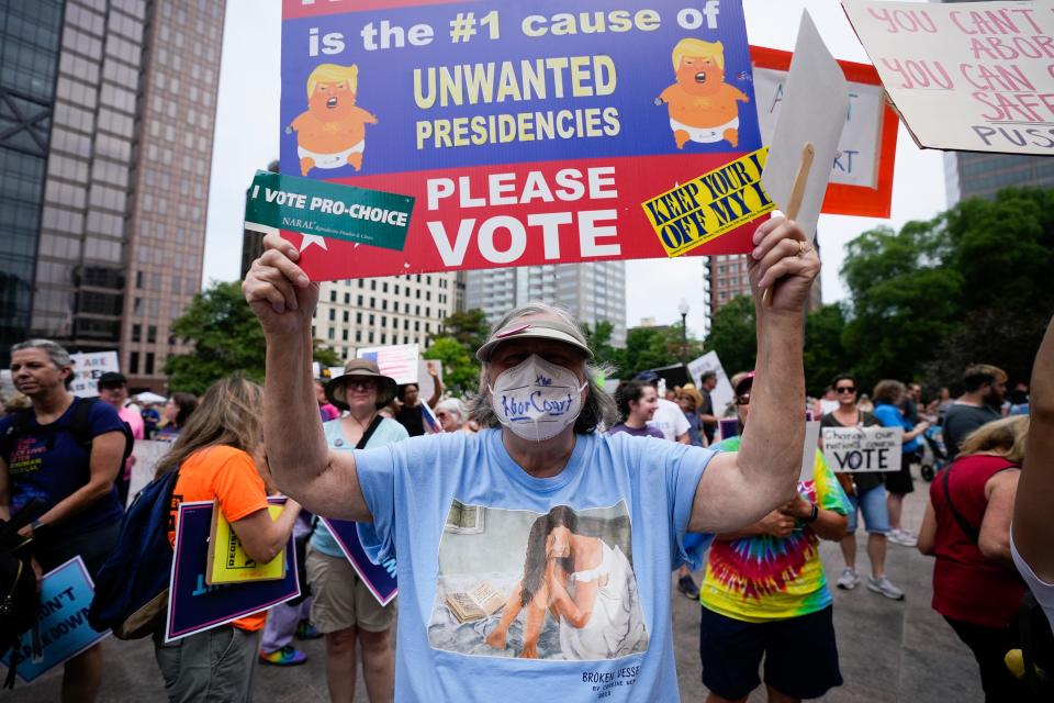 Patti Ray of Morrow County holds a sign and wears a mask reading, “The Abort Court” during a rally organized by the Democratic Party at the Ohio Statehouse following the overturning of Roe v Wade by SCOTUS.