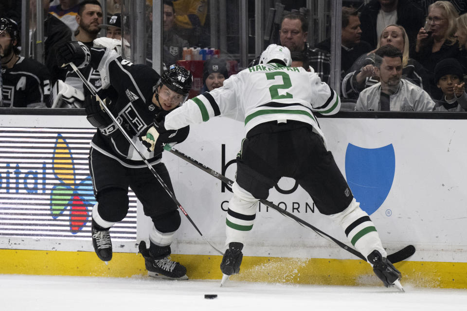 Los Angeles Kings center Blake Lizotte (46) controls the puck past Dallas Stars defenseman Jani Hakanpaa (2) during the second period of an NHL hockey game, Saturday, March 9, 2024, in Los Angeles. (AP Photo/Kyusung Gong)