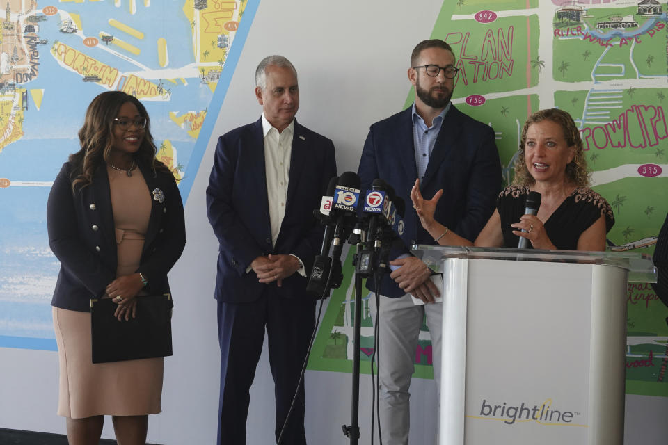 U.S. Rep. Debbie Wasserman Schultz, D-Fla., speaks during a news conference at the Brightline station in Fort Lauderdale on Monday, Aug., 15, 2022. Looking on is Brightline CEO Patrick Goddard. The Florida Department of Transportation and Brightline was awarded a $25 million grant to enhance safety along the Florida East Coast Railway- Brightline corridor between Miami-Dade and Brevard counties. (Joe Cavaretta/South Florida Sun-Sentinel via AP)