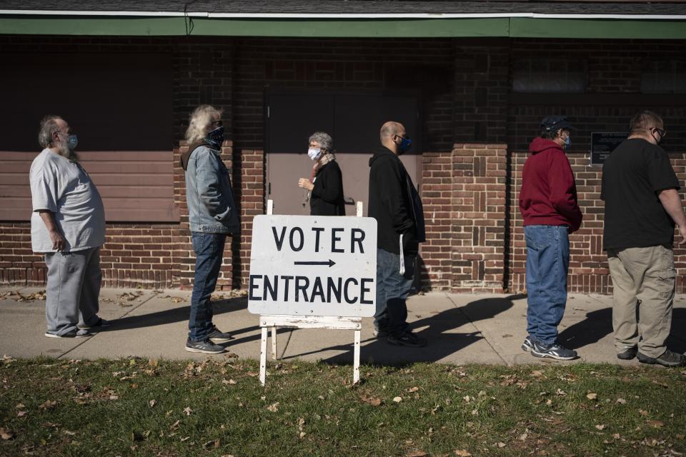 FILE - In this Tuesday, Nov. 3, 2020, file photo, voters wait in line outside a polling center on Election Day, in Kenosha, Wis. Republican lawmakers in Wisconsin and a statewide commission are in a standoff to determine who will oversee elections next year in one of the most important presidential battleground states. The conflict over reappointing the nonpartisan election director is rooted in the lies surrounding the last presidential election. (AP Photo/Wong Maye-E, File)