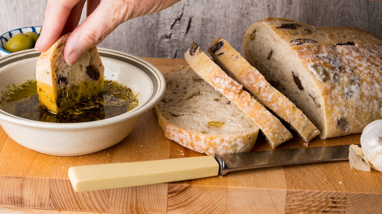 Dipping olive bread in oil