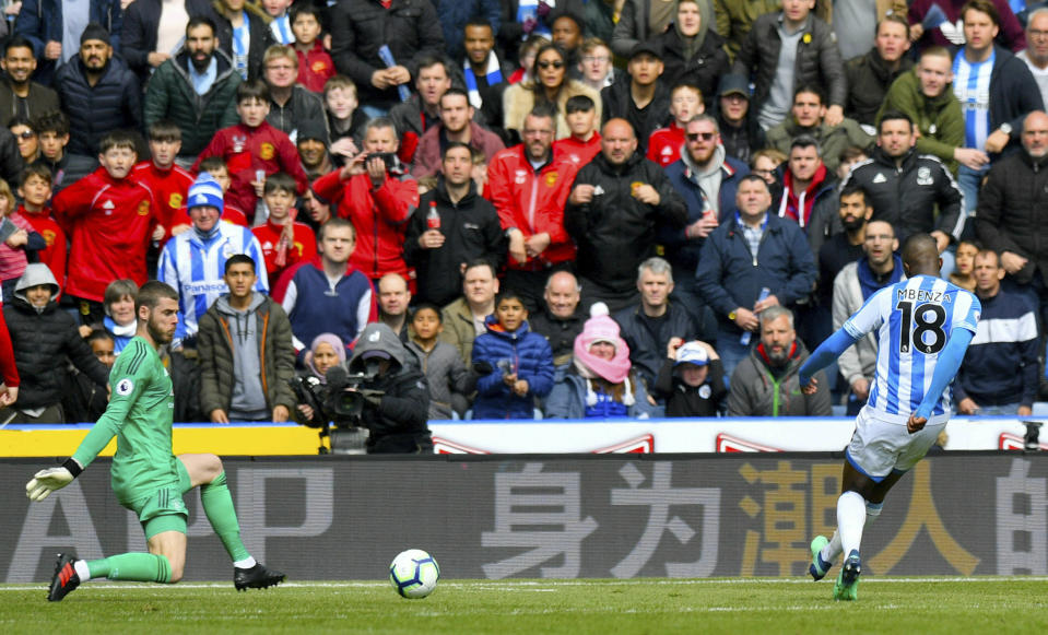 Huddersfield Town's Isaac Mbenza scores against Manchester United during the English Premier League soccer match at the John Smith's Stadium, Huddersfield, England, Sunday May 5, 2019. (Anthony Devlin/PA via AP)