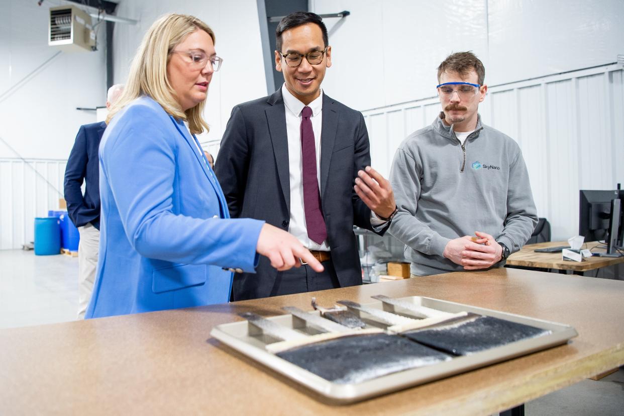 SkyNano CEO Anna Douglas, left, explains the company's carbon nanotubes. The nanotubes are made out of carbon dioxide turned into solid carbon material.