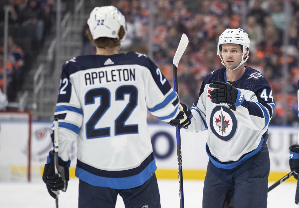 Winnipeg Jets' Josh Morrissey (44) and Mason Appleton (22) celebrate a goal against the Edmonton Oilers during the first period of an NHL hockey game in Edmonton, Alberta, Saturday, Oct. 21, 2023. (Jason Franson/The Canadian Press via AP)
