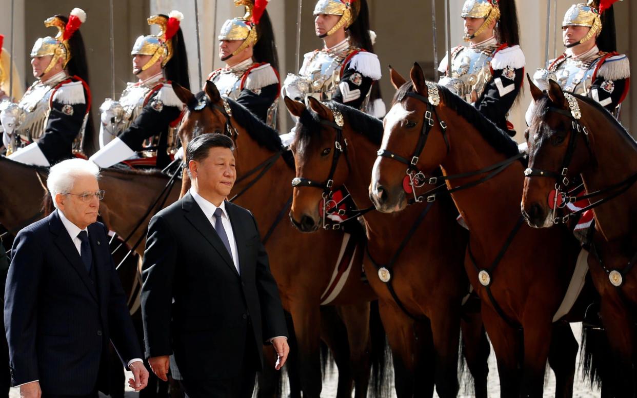 Chinese President Xi Jinping and Italian President Sergio Mattarella inspect an honour guard at the Quirinal Palace in Rome - REUTERS