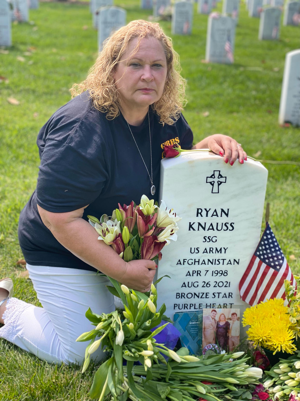 Knauss Selph sits at the grave of her son, Ryan, at Arlington National Cemetery. (Courtesy Paula Knauss Selph)