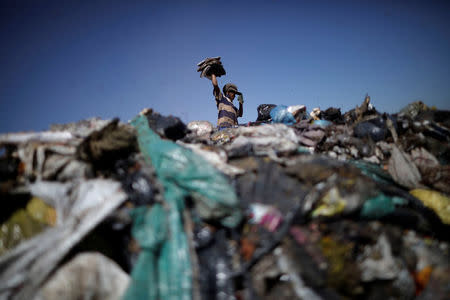 A child works at 'Lixao da Estrutural', Latin America's largest rubbish dump, in Brasilia, Brazil, January 19, 2018. REUTERS/Ueslei Marcelino