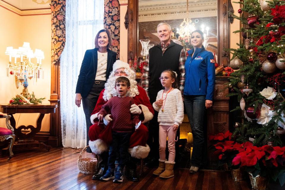 Casey DeSantis and her family take photos with Santa, Gov. Kim Reynolds and First Gentleman Kevin Reynolds during a Christmas party at the governor's mansion Sunday, Dec. 17, 2023, at Terrace Hill in Des Moines.