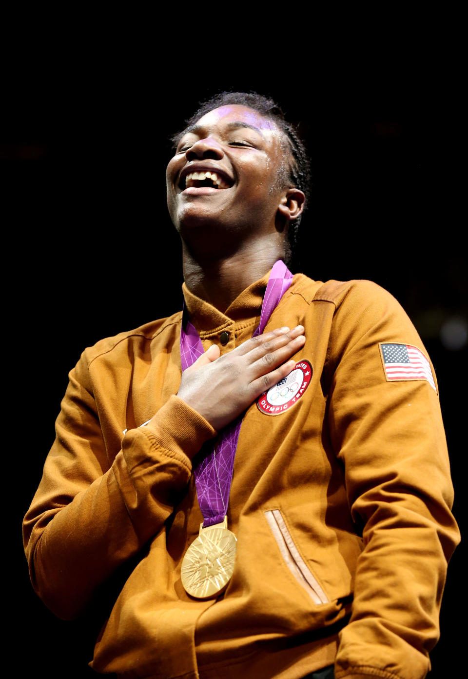 Gold medalist <a href="http://sports.yahoo.com/olympics/boxing/claressa-shields-1132139/" data-ylk="slk:Claressa Shields;elm:context_link;itc:0;sec:content-canvas" class="link ">Claressa Shields</a> of the United States celebrates on the podium during the medal ceremony for the Women's Middle (75kg) Boxing final bout on Day 13 of the London 2012 Olympic Games at ExCeL on August 9, 2012 in London, England. (Getty Images)