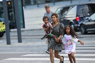 A woman and children flee the Field's shopping center after a shooting, in Copenhagen, Denmark, Sunday, July 3, 2022. Danish police said Sunday that several people were shot at a Copenhagen shopping mall, one of the largest in Scandinavia. Copenhagen police said that one person has been arrested in connection with the shooting at the Field’s shopping mall, which is close to the city's airport. Police tweeted that “several people have been hit,” but gave no other details. (Olafur Steinar Gestsson/Ritzau Scanpix via AP)