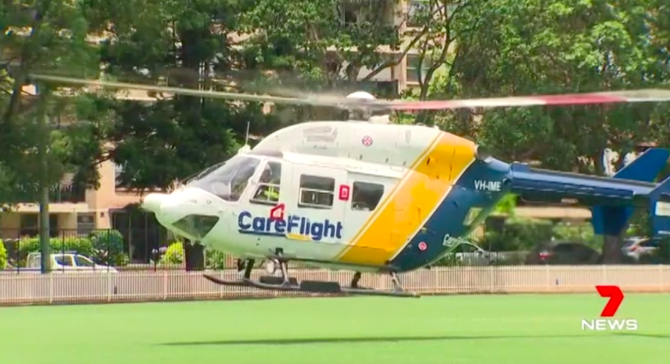 A CareFlight helicopter touches down near the Scientology headquarters in Sydney after an alleged stabbing inside the complex. Source: 7news